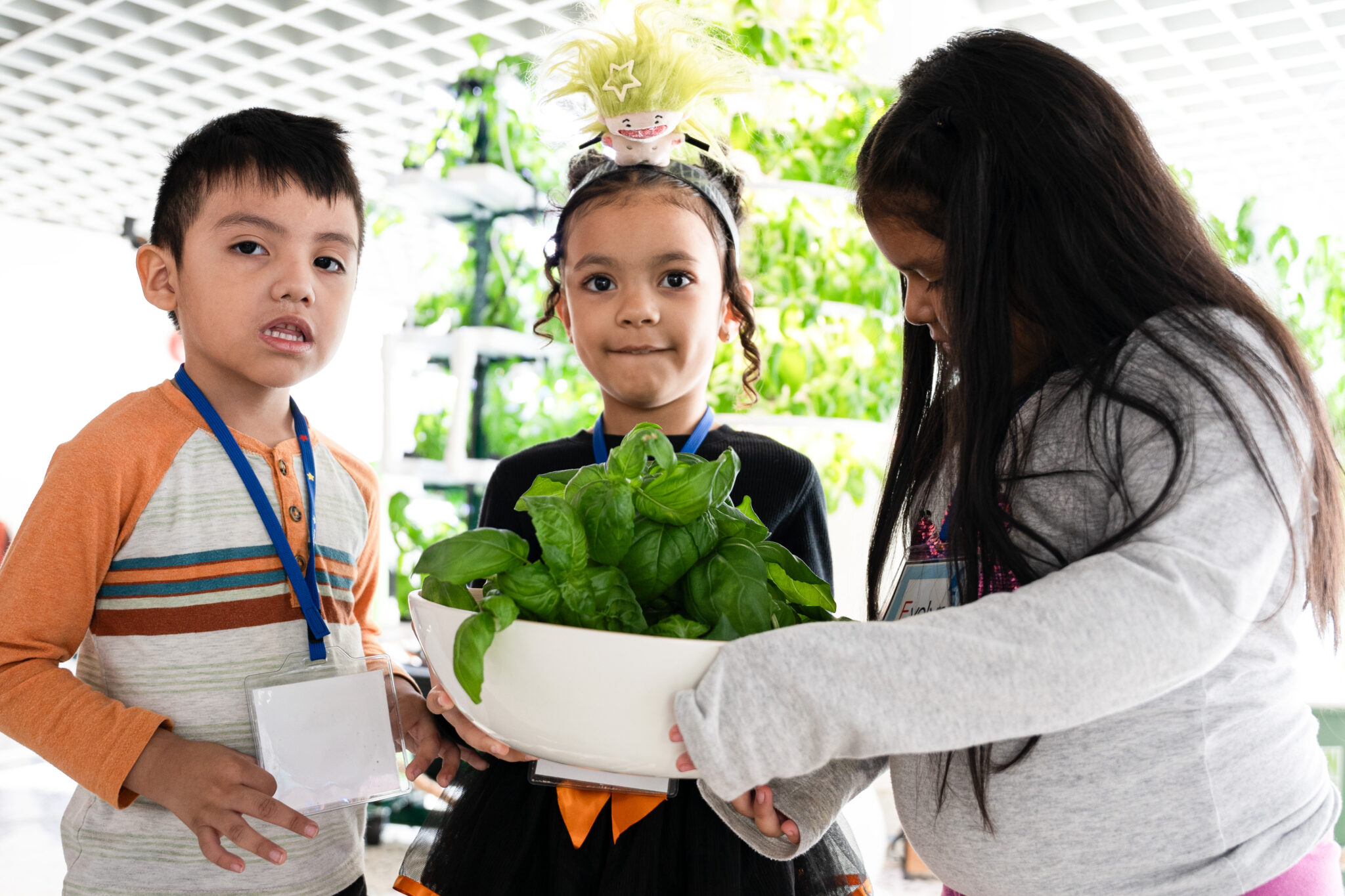 Students demonstrate their harvest at the NYSCI exhibit.