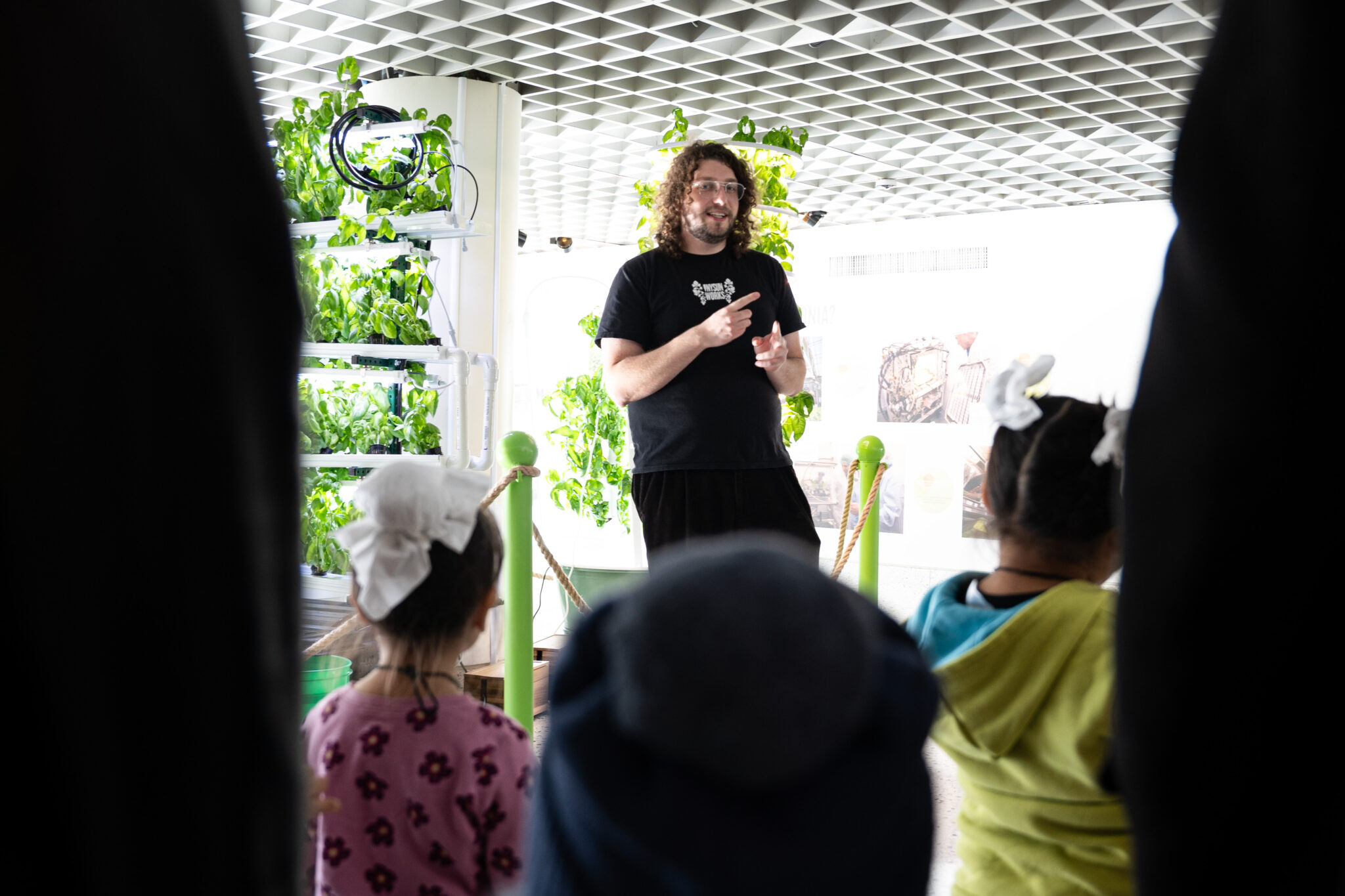 NY Sun Works staff member gives introduction to Hydroponics for students at the NYSCI exhibit.