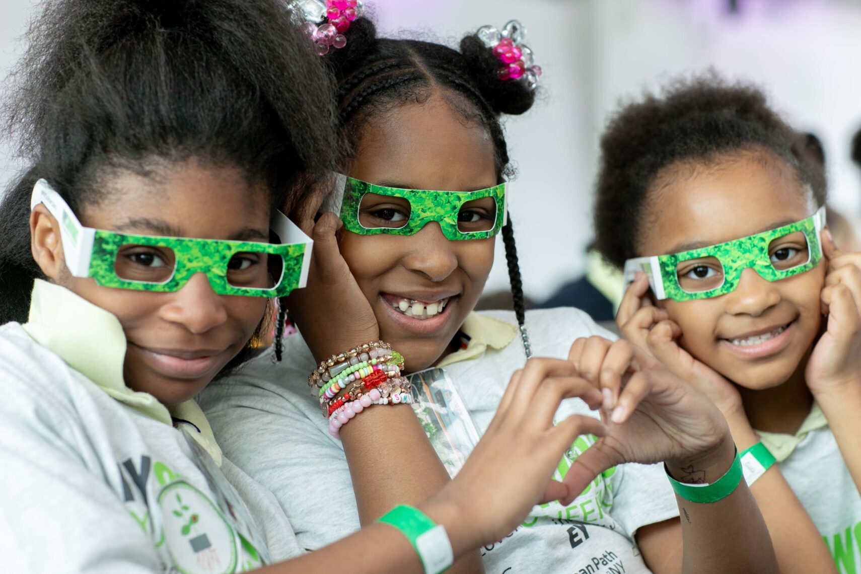 Three students sit next to each other at youth conference